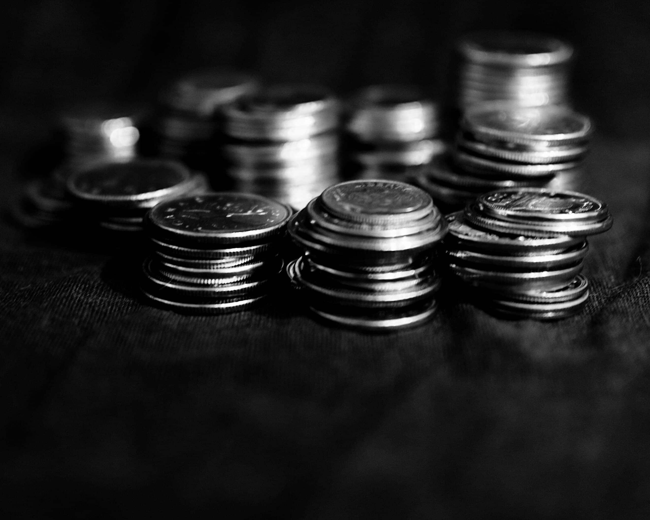 Various coins stacked on a table.