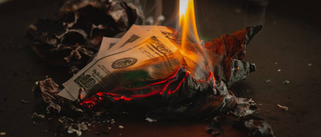 Money, on fire, reduced to ash.
