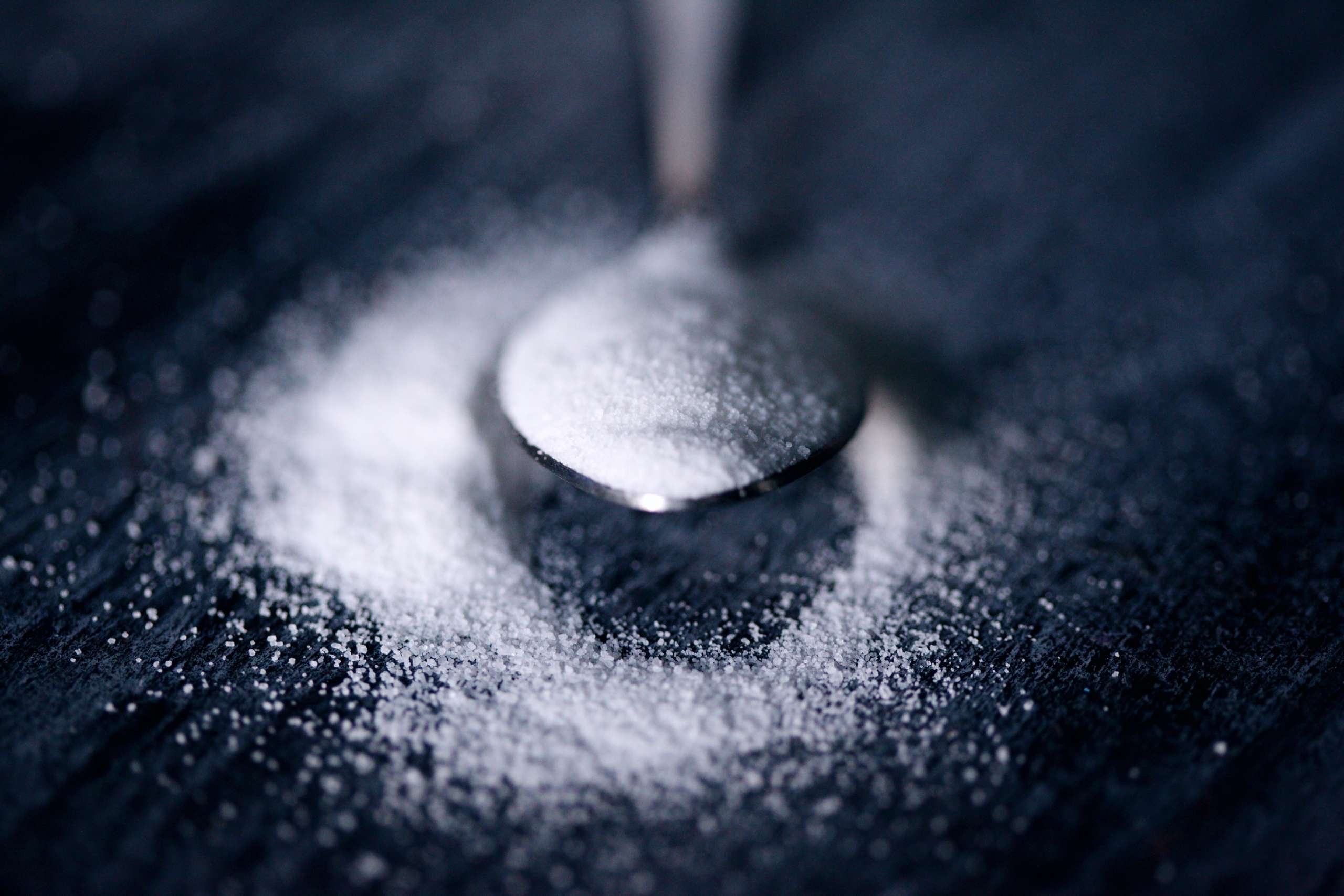 White sugar on a spoon.